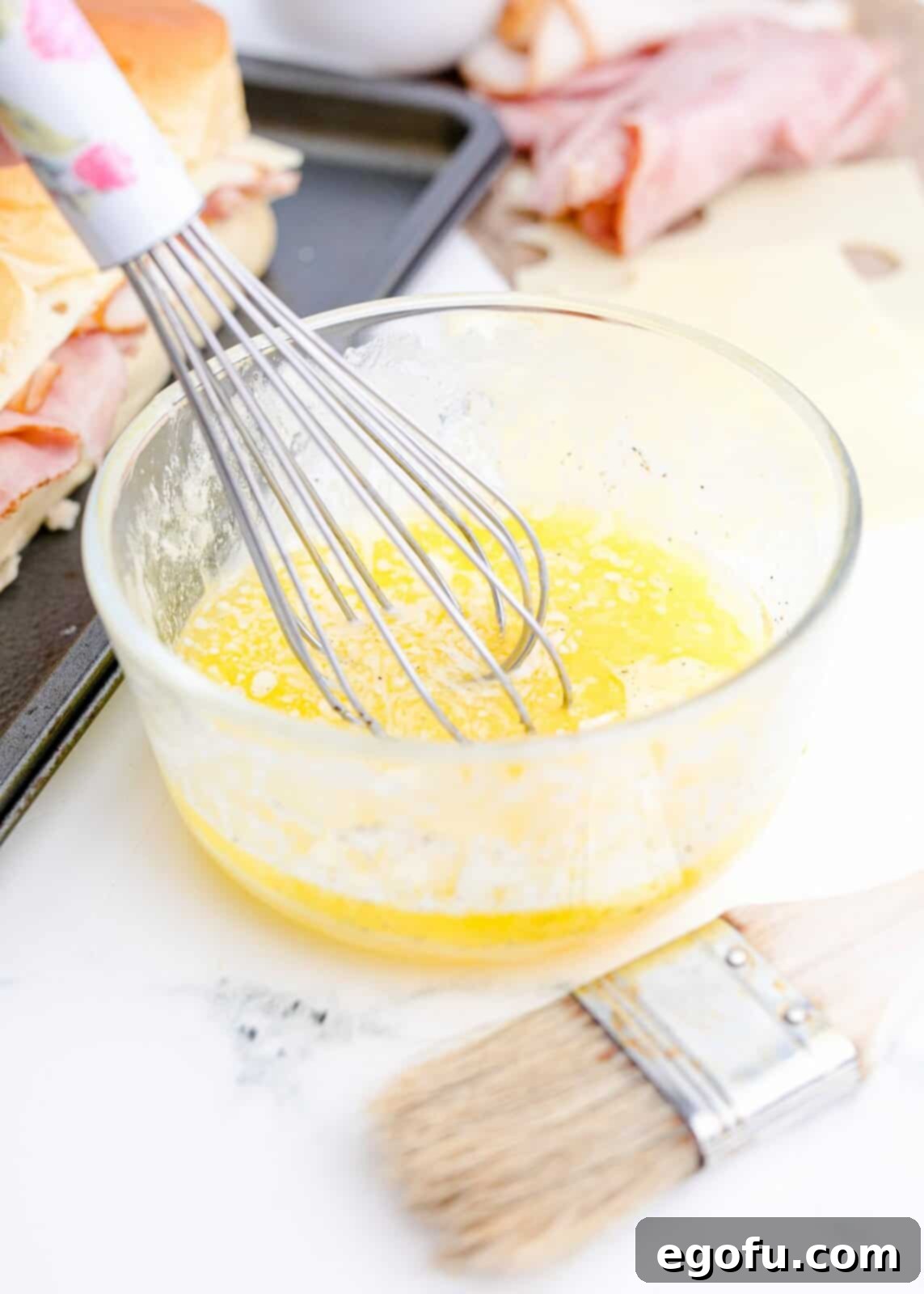 Butter, egg and pepper whisked together in bowl.