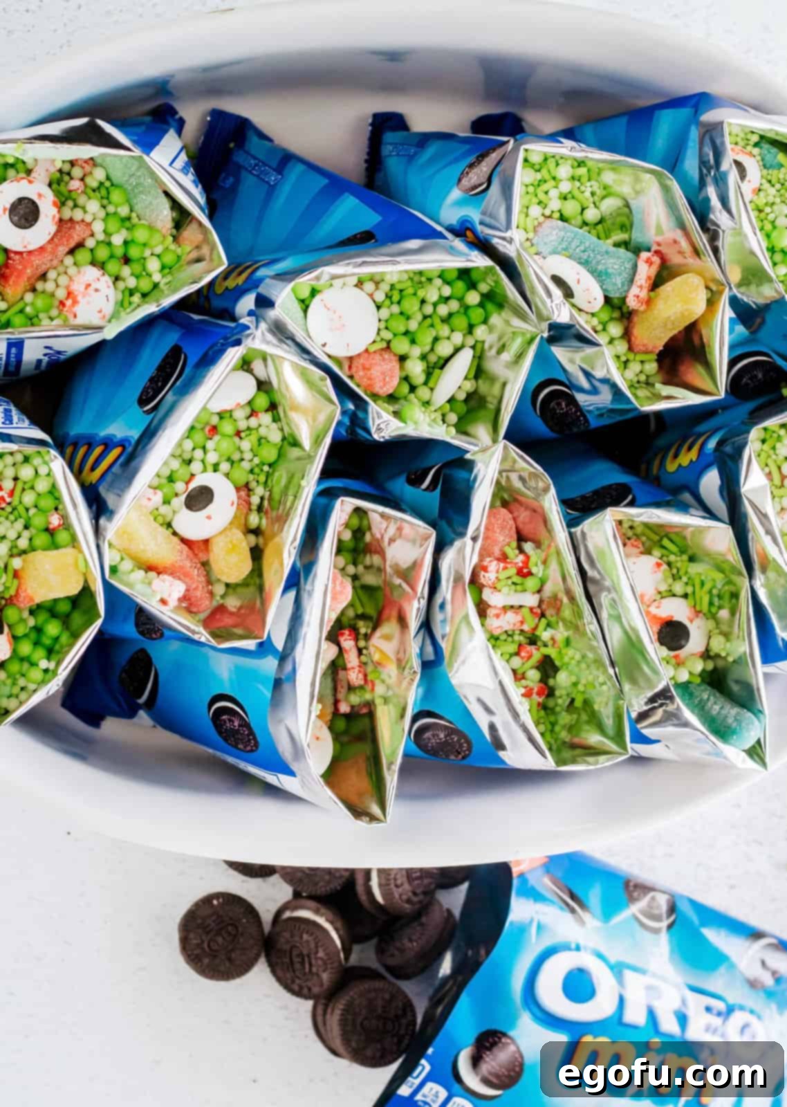 Green pearl sprinkles being added as a final decorative touch to the Witches Brew Snack Bags.