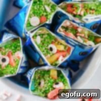 Close up overhead square image of Witches Brew Snack Bags in white dish.