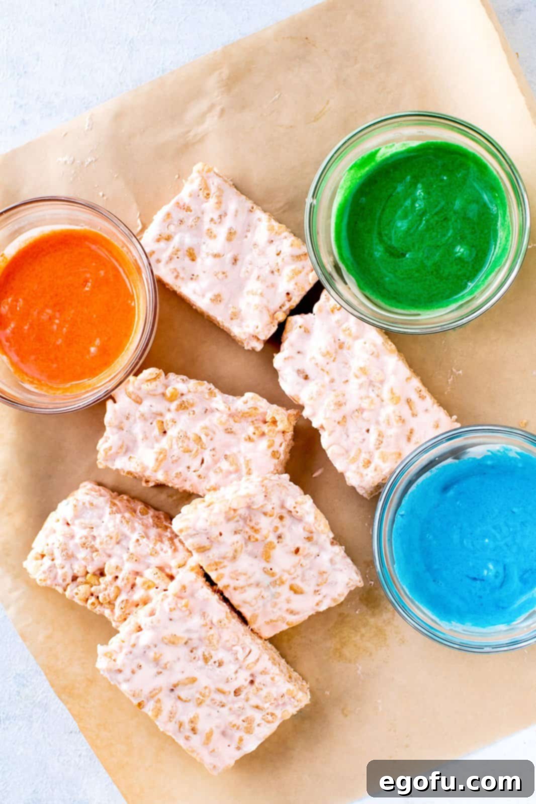 Creepy Crispy Critters 8 Cut Rice Krispies Treats with melted and colored chocolate in bowls.