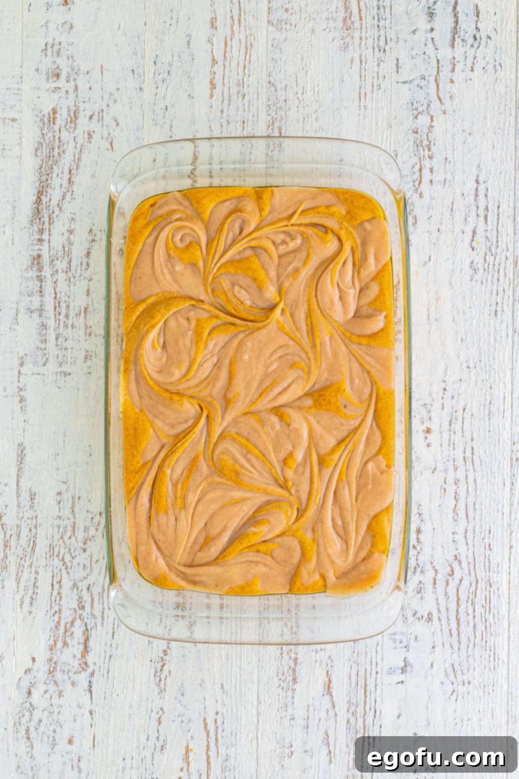 Cream cheese mixture swirled into the cake batter using a butter knife.