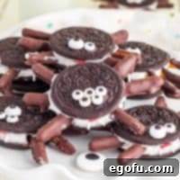 Spooktacular Oreo Spiders 13 Square image of stacked Halloween Oreo Spiders on white plate.