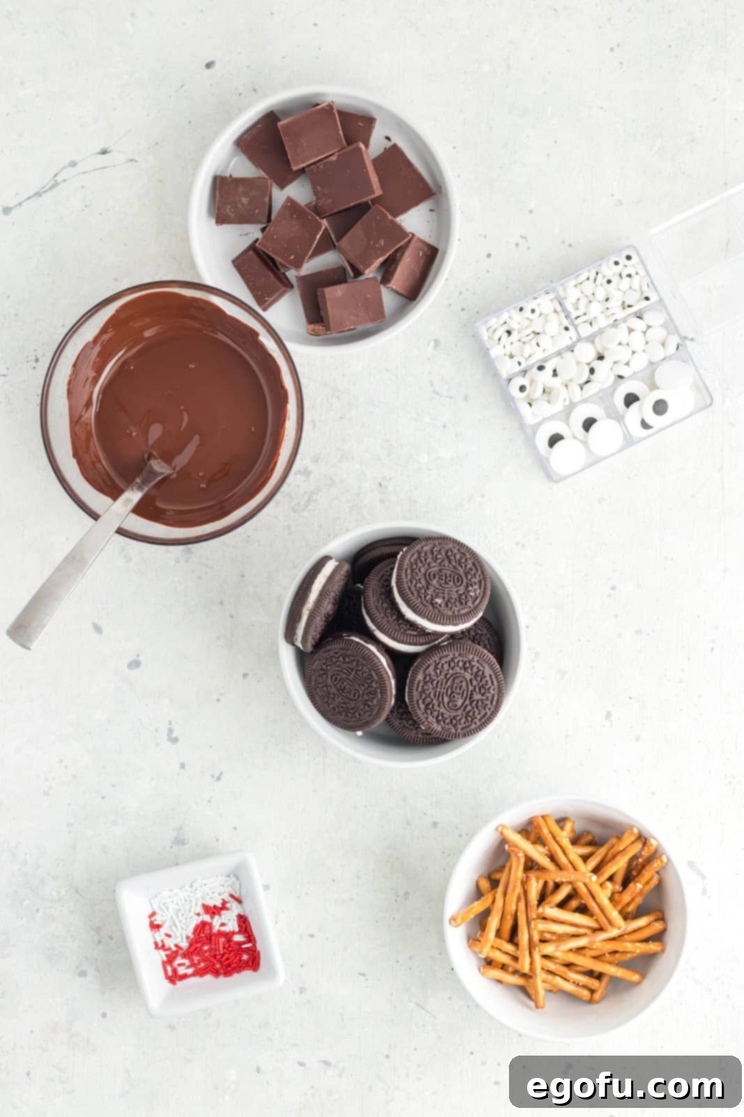 Spooktacular Oreo Spiders 4 Ingredients needed: Double Stuf Oreos, pretzel sticks, dark chocolate chips, candy eyes and red and white Jimmie sprinkles.