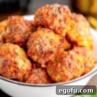 Close up of finished Air Fryer Sausage Balls stacked up in bowl.