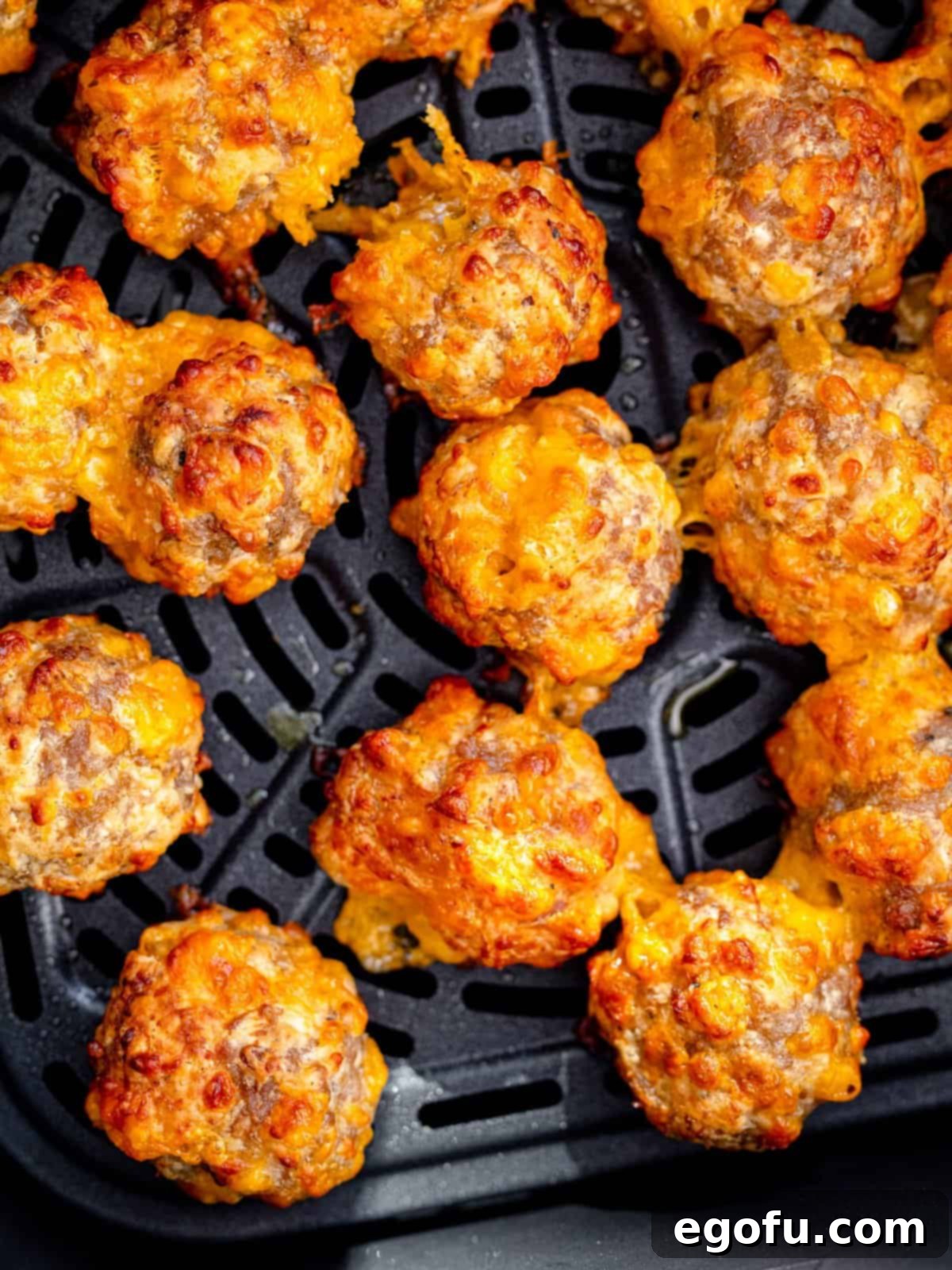 Finished Sausage Balls in air fryer basket.