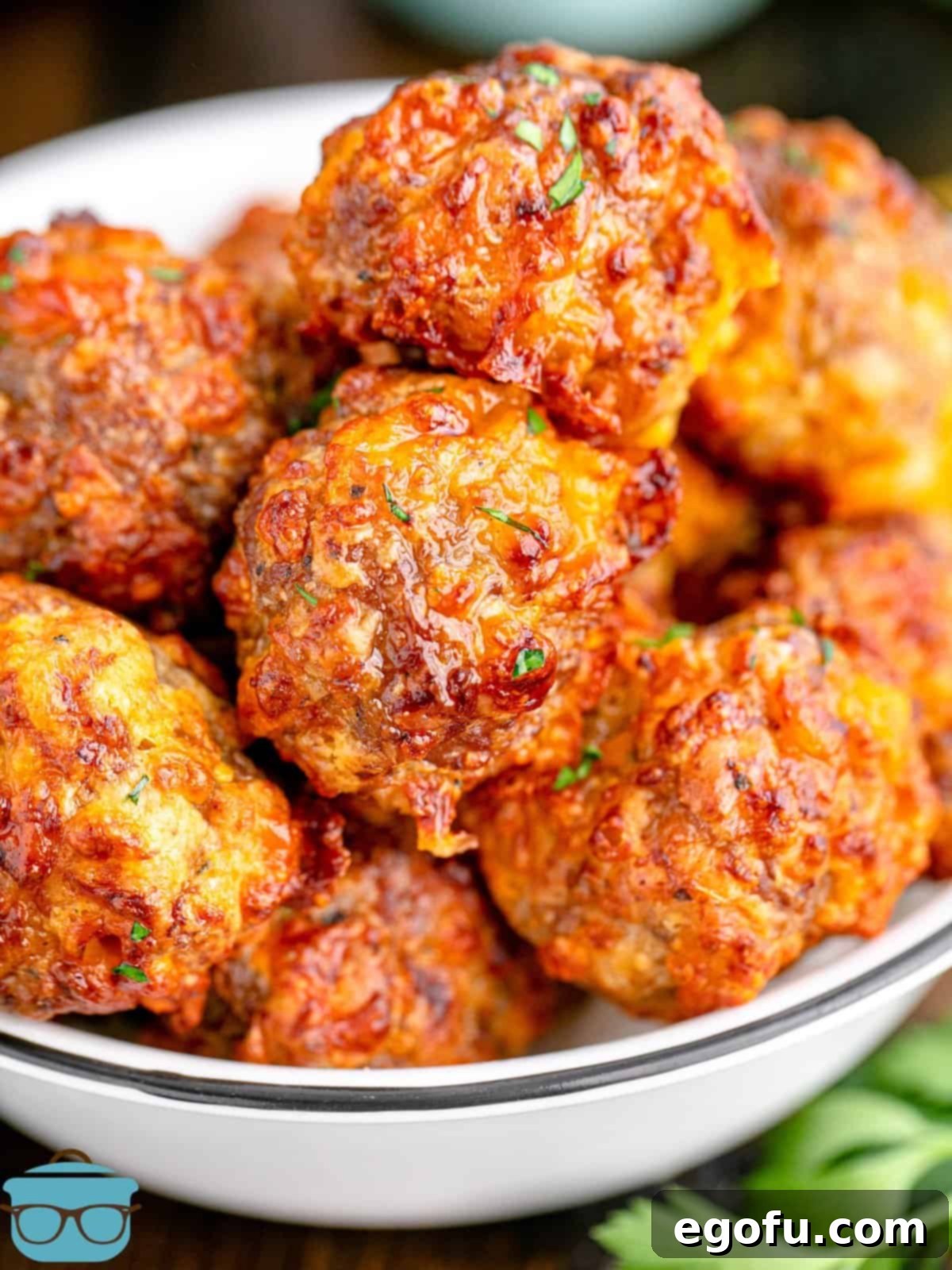 Air Fryer Sausage Balls stacked in white bowl.