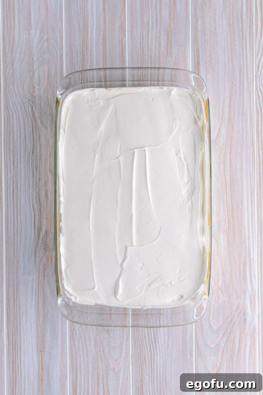 Pudding topped with whipped topping.