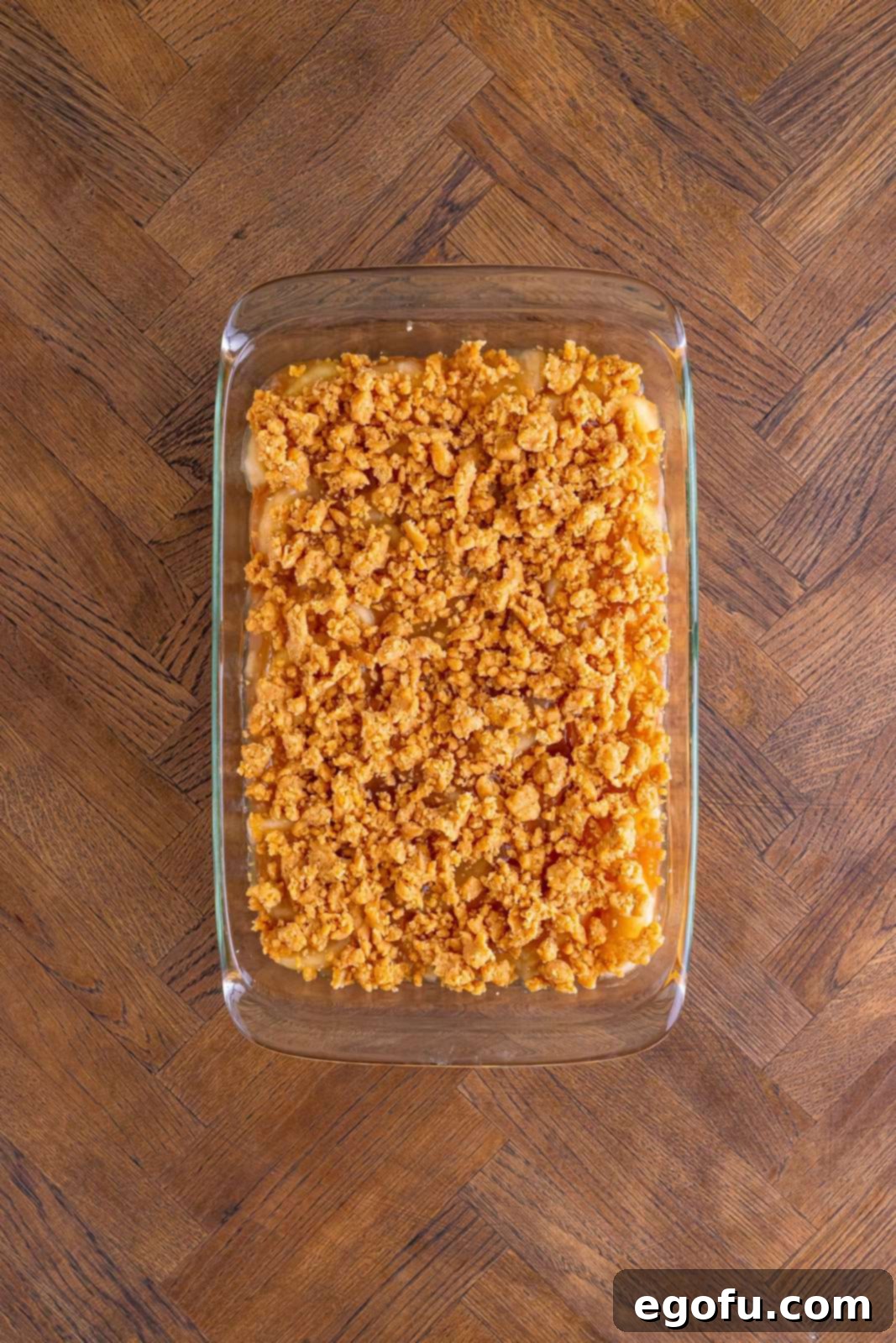 Classic Apple Crumble Bars 13 The remaining crust/crumble mixture is artfully sprinkled over the top of the apple pie filling, creating a textured and inviting surface before the final bake.