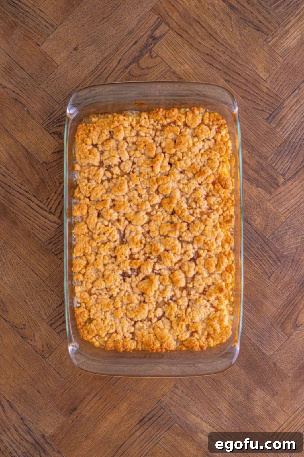 Classic Apple Crumble Bars 14 The finished Apple Crumble Bars, freshly out of the oven, display a perfectly golden brown topping and bubbling apple filling within the pan, ready for cooling.