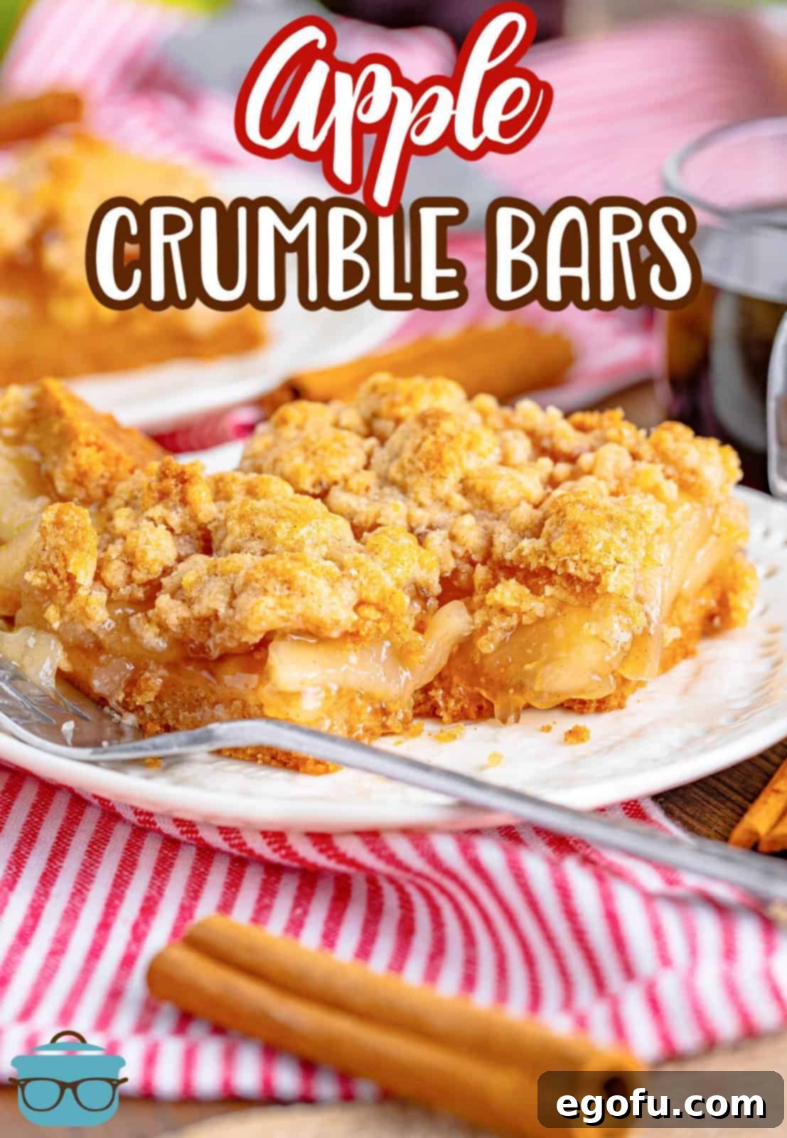 Classic Apple Crumble Bars 3 A close-up of a single Apple Crumble Bar on a white plate, with a bite taken out, revealing the soft apple filling and golden crust, ready to be enjoyed.