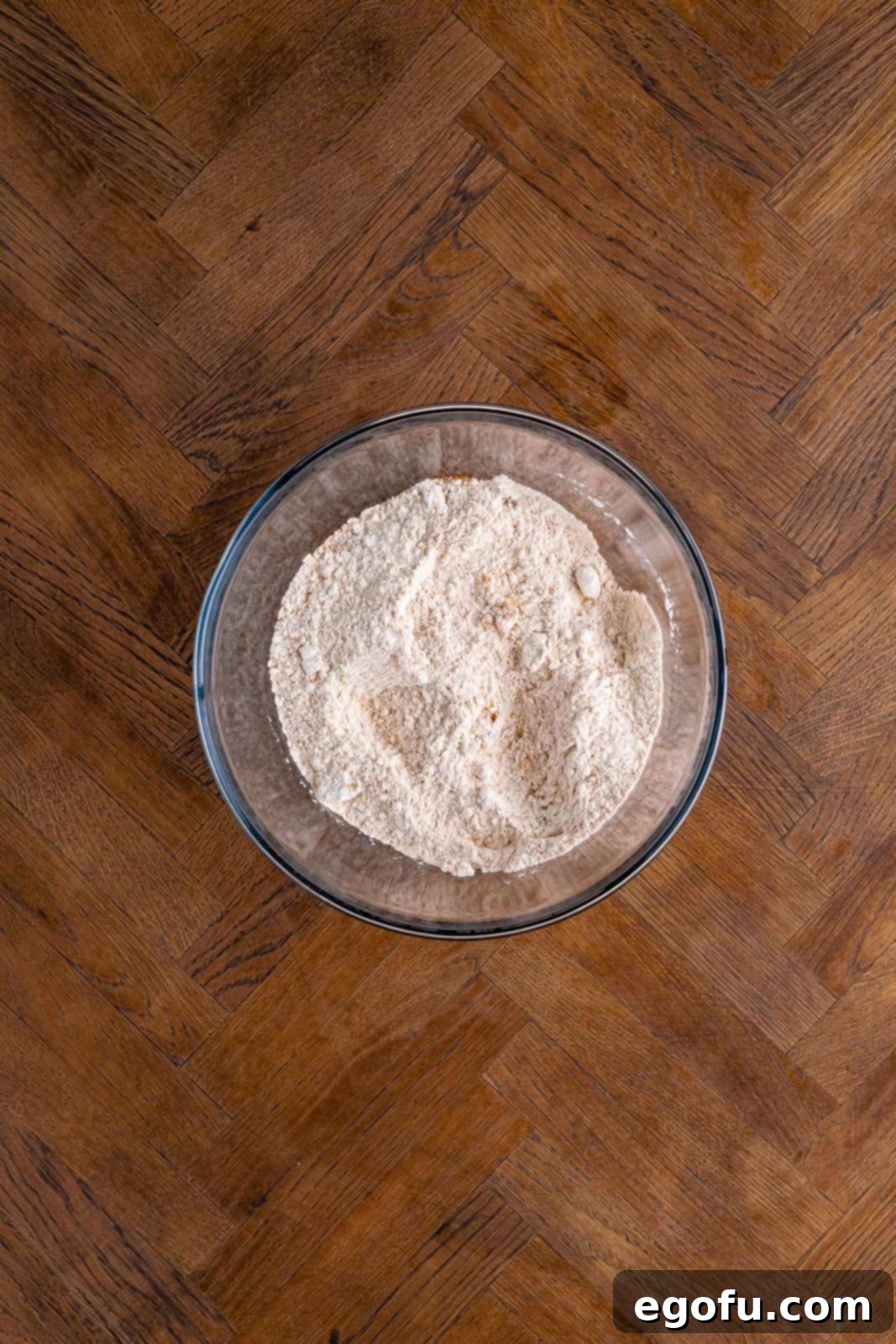 Classic Apple Crumble Bars 5 All dry ingredients: flour, granulated sugar, brown sugar, cinnamon, baking powder, salt, and nutmeg, expertly whisked together in a large bowl, ready for the next step.