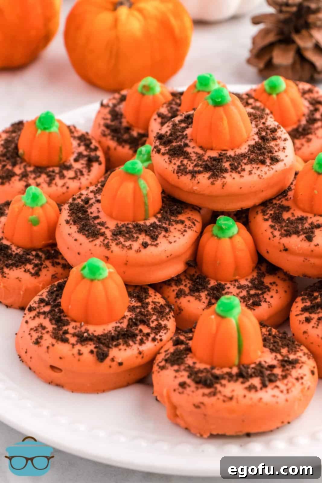 Spiced Pumpkin Patch Cookies 2 Stacked Pumpkin Patch Cookies on a white platter, showcasing their vibrant orange color and pumpkin candy tops.