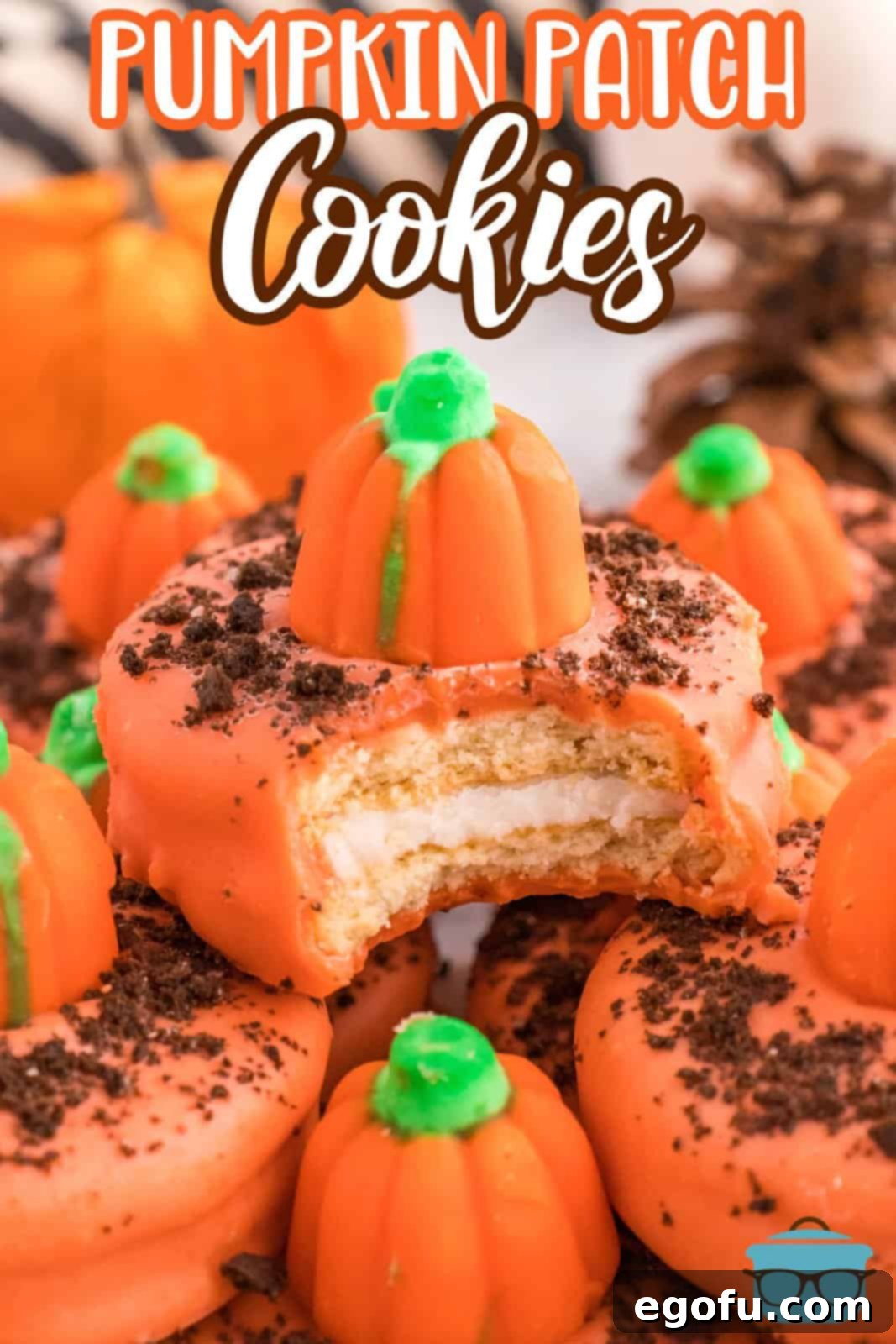 Spiced Pumpkin Patch Cookies 3 Close-up of a Pumpkin Patch Cookie with a bite taken out, showing the Oreo inside and orange chocolate coating with cookie crumbs and a pumpkin candy.