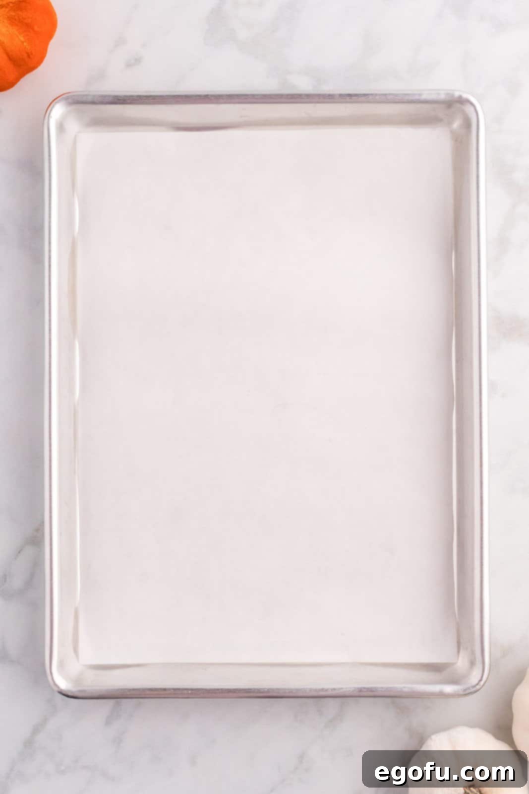 Spiced Pumpkin Patch Cookies 5 A baking sheet lined with clean parchment paper, ready for cookie preparation.