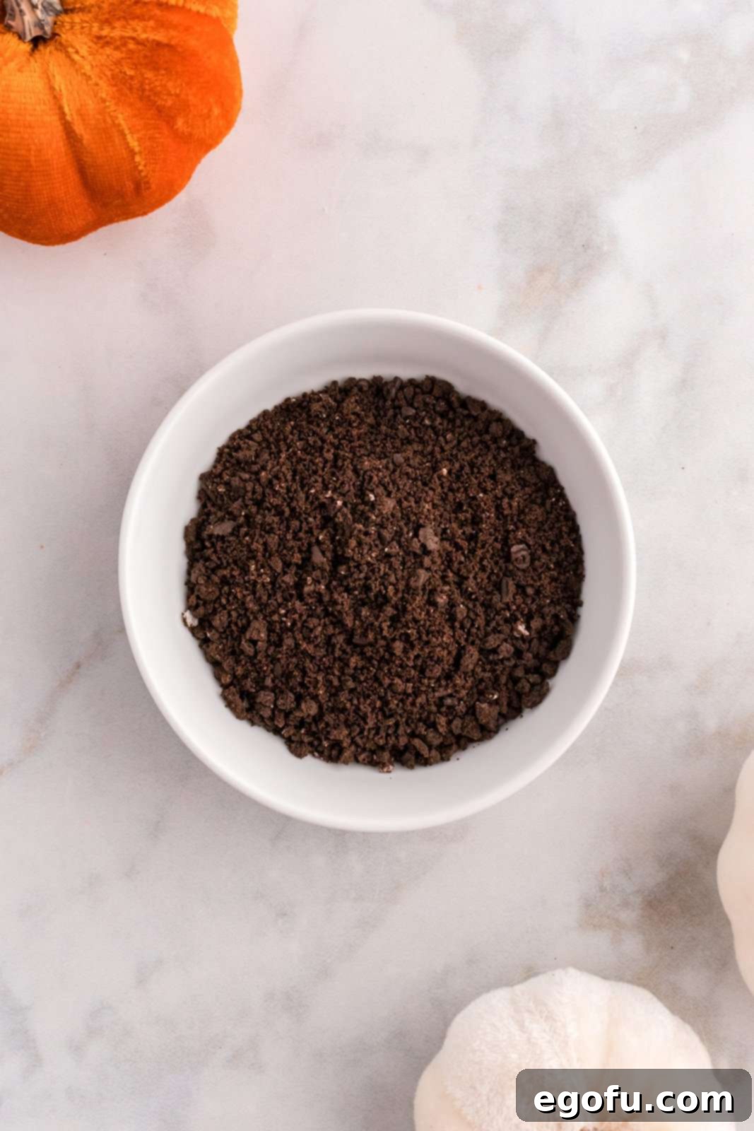 Spiced Pumpkin Patch Cookies 6 Finely crushed chocolate Oreo cookies in a white bowl, ready to be used as 'dirt' topping.