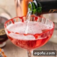 Crimson Embrace Elixir 11 Champagne being poured into glass for the Vampire's Kiss Cocktail.