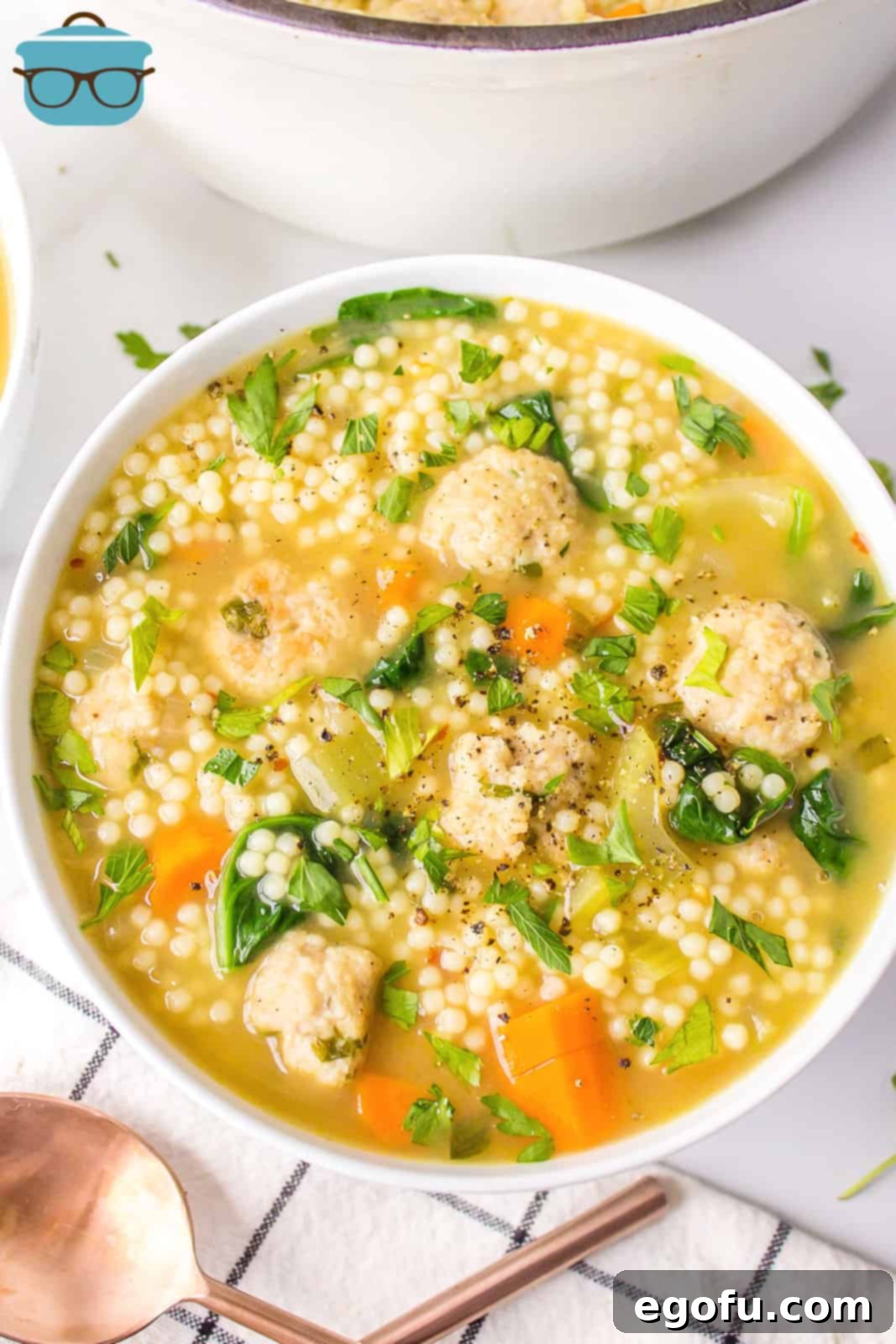 Italian Celebration Soup 12 Overhead of a white bowl filled with Italian Wedding Soup.