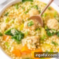 Italian Celebration Soup 13 Square close up of Italian Wedding Soup in bowl with gold spoon.