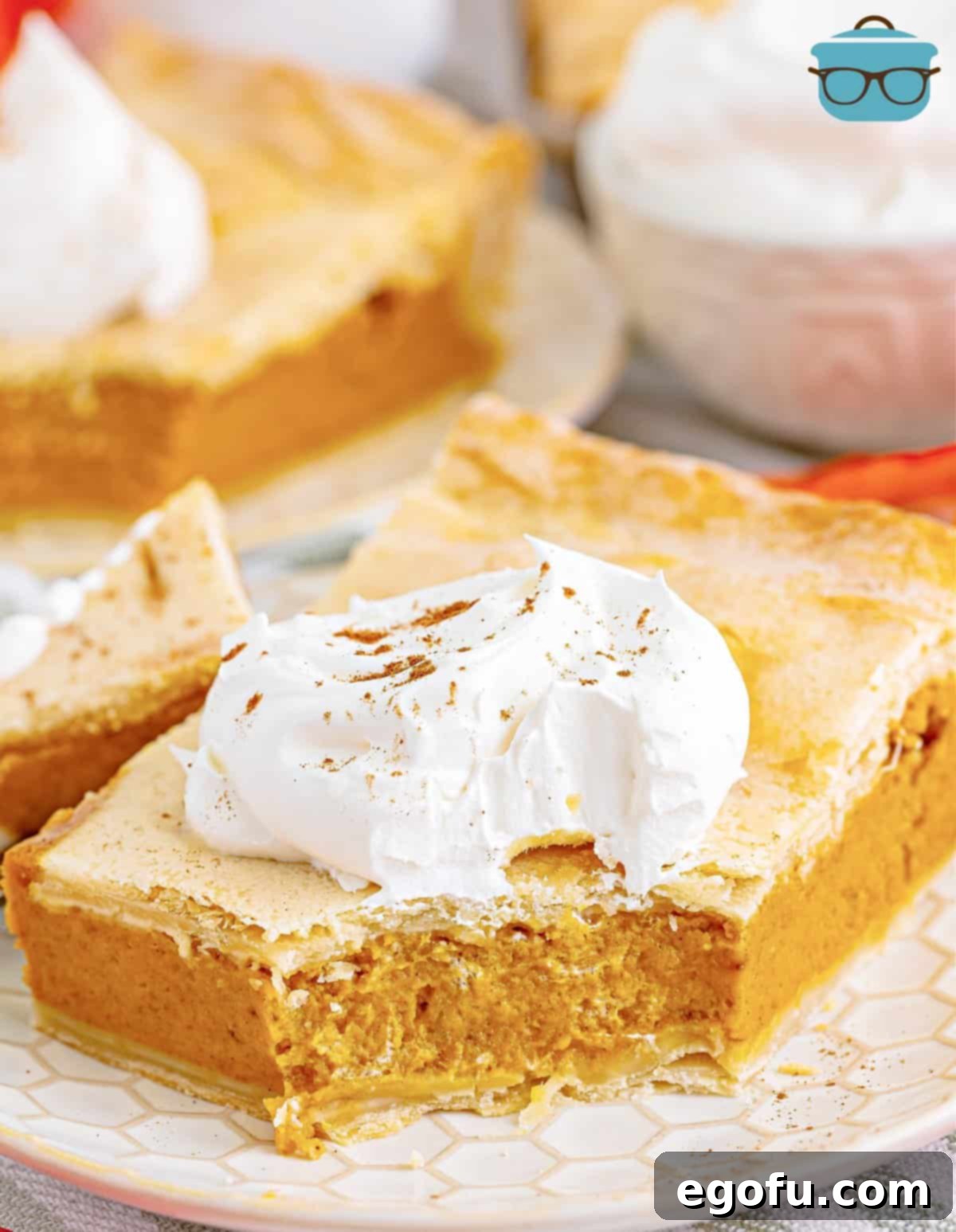 slice of pumpkin slab pie on a white plate with a bite taken out.
