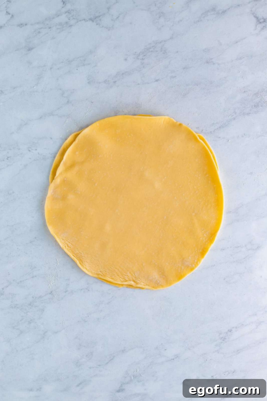 Two pie crusts layered on top of one another.