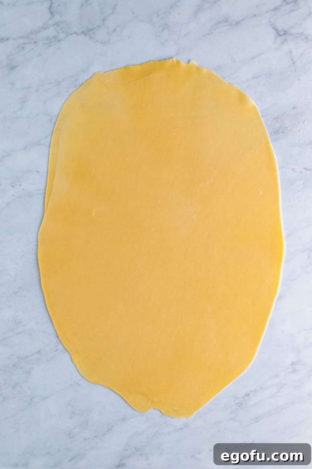 Two pie crusts rolled out into one large pie crust.