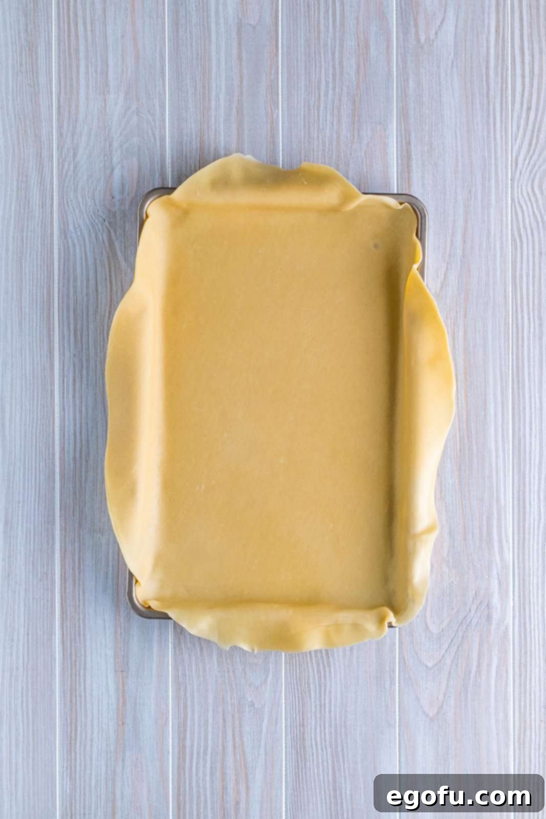 Pie crust placed in the bottom of a baking pan.