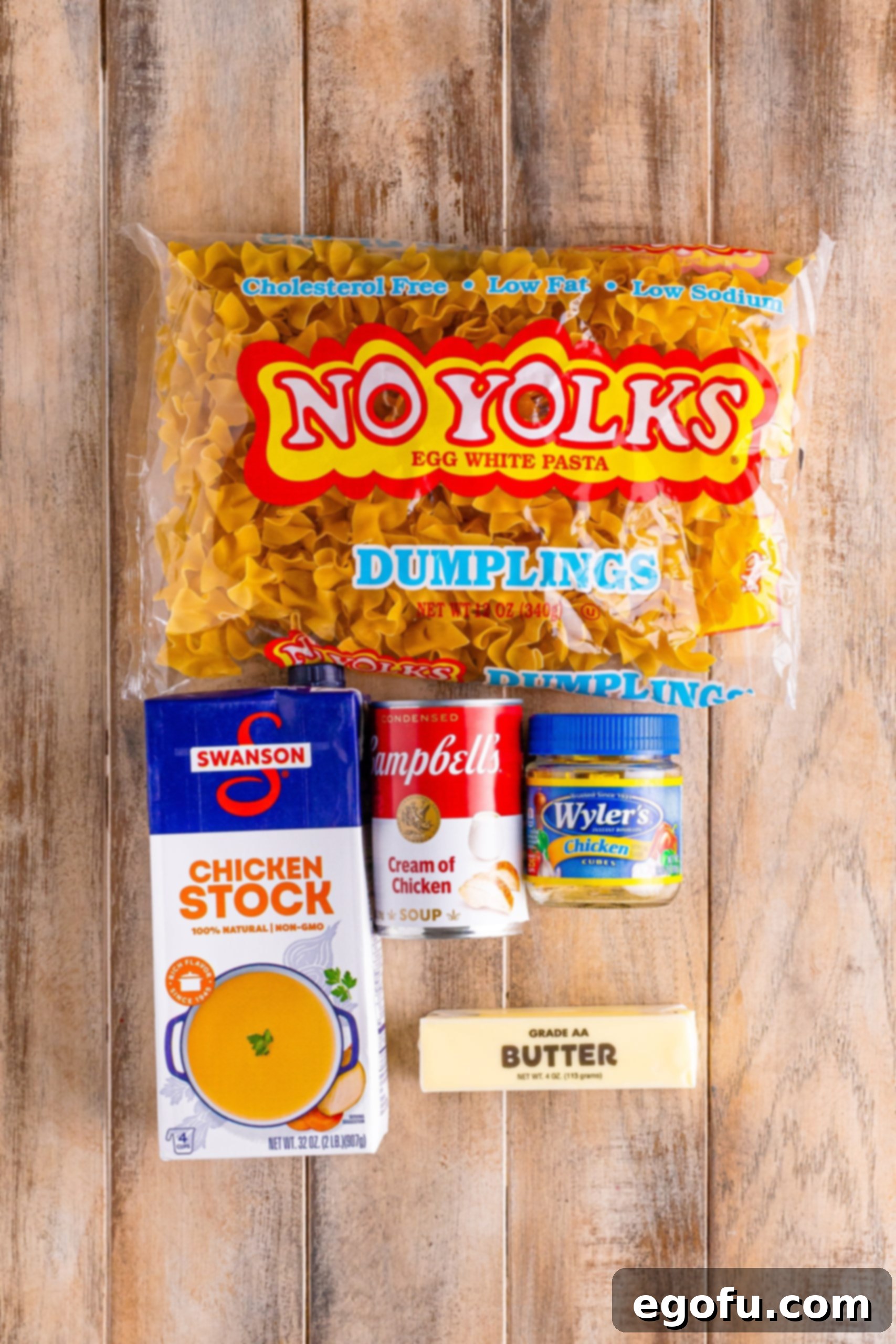 Campus Noodle Comfort 4 Egg noodles, chicken stock, butter, chicken bouillon cube, and cream of chicken soup laid out as ingredients for Cafeteria Noodles.