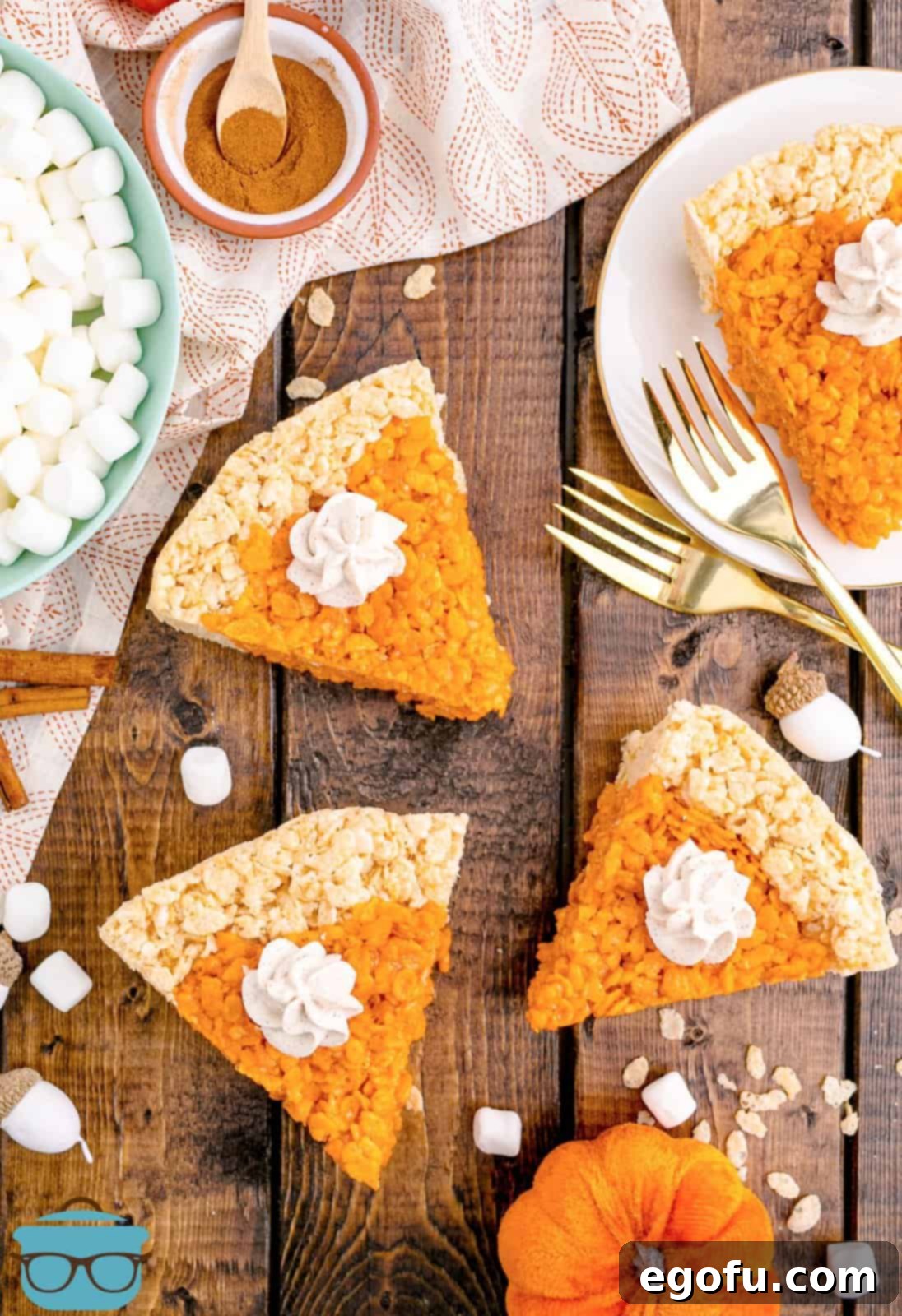Overhead of cut Pumpkin Pie Rice Krispies Treats on wooden board.