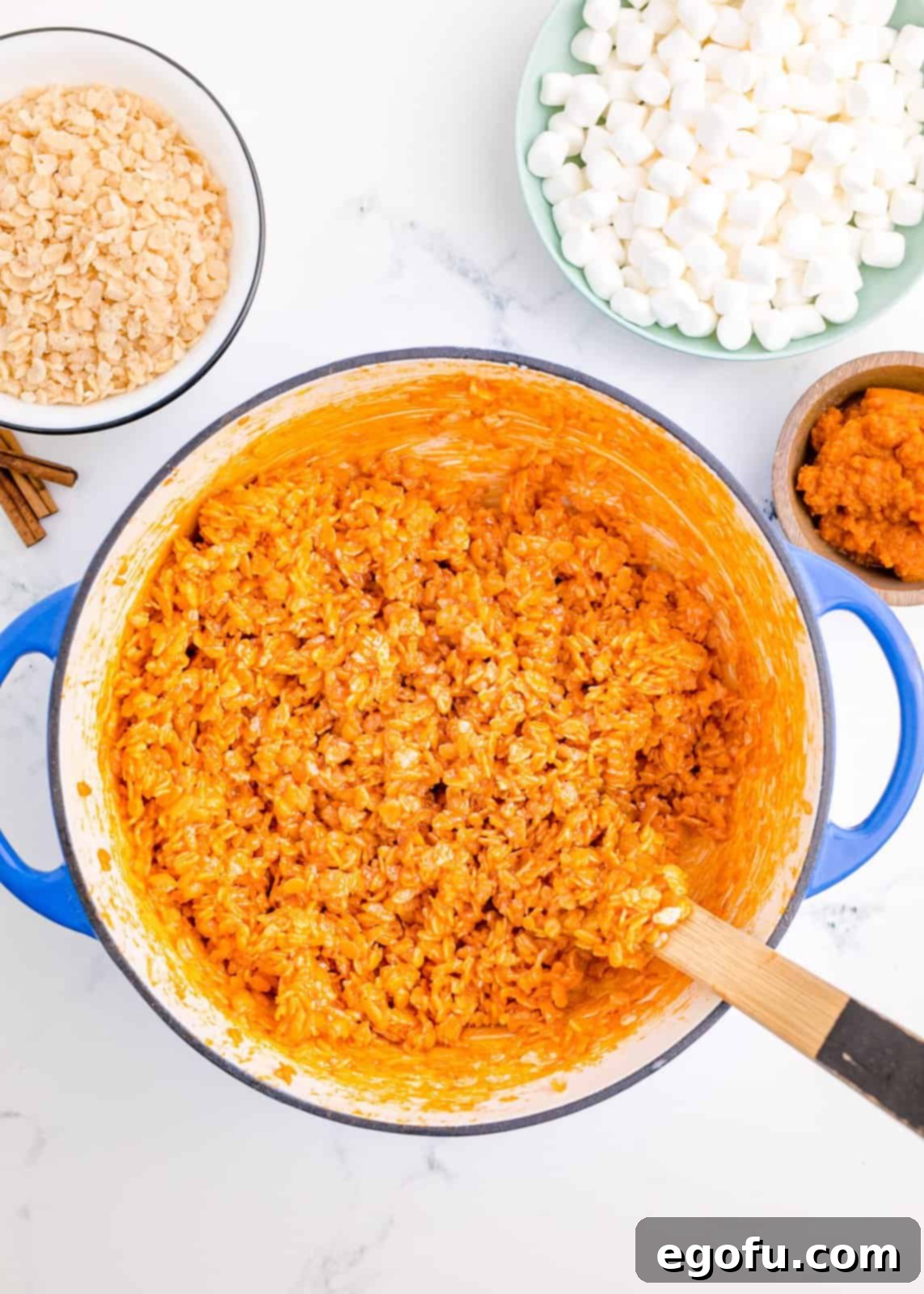 Orange food coloring mixed in with Rice Krispies until everyone is coated.