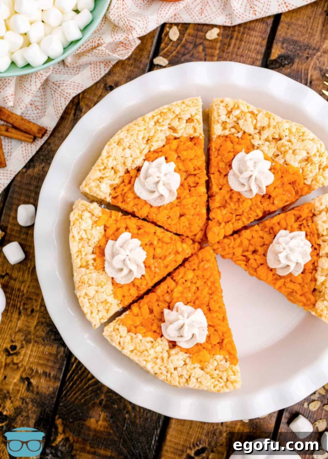 Overhead of Pumpkin Pie Rice Krispies Treats in pie plate with slice missing.