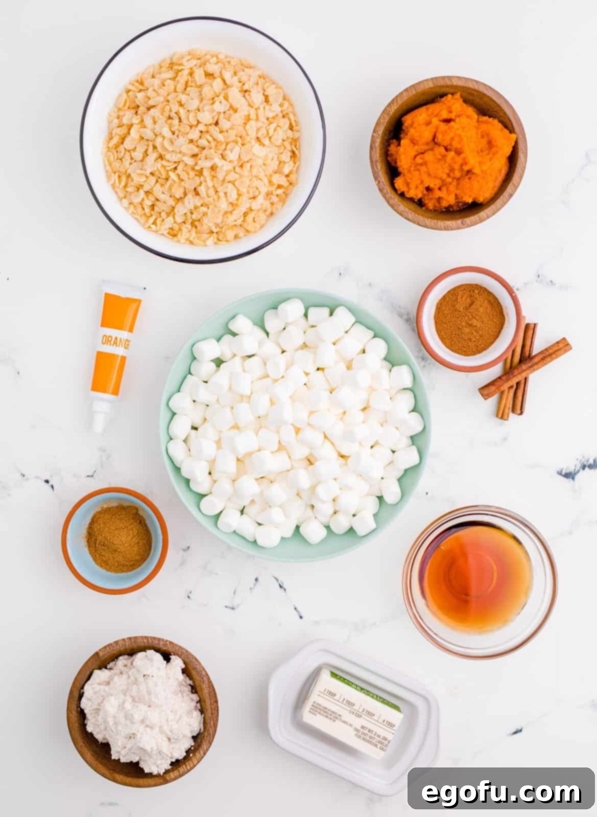 Ingredients needed: salted butter, mini marshmallows, maple syrup, Rice Krispies, pumpkin pie spice, pumpkin puree, cinnamon, orange food coloring and cinnamon whipped cream, optional.
