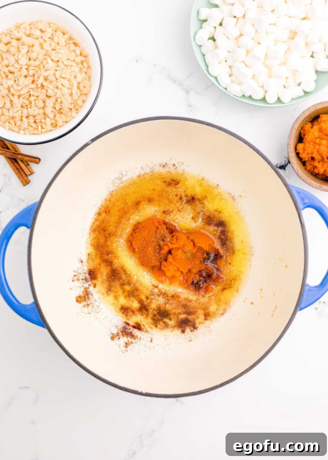 Melted butter, pumpkin pie spice, pumpkin puree and cinnamon in dutch oven.
