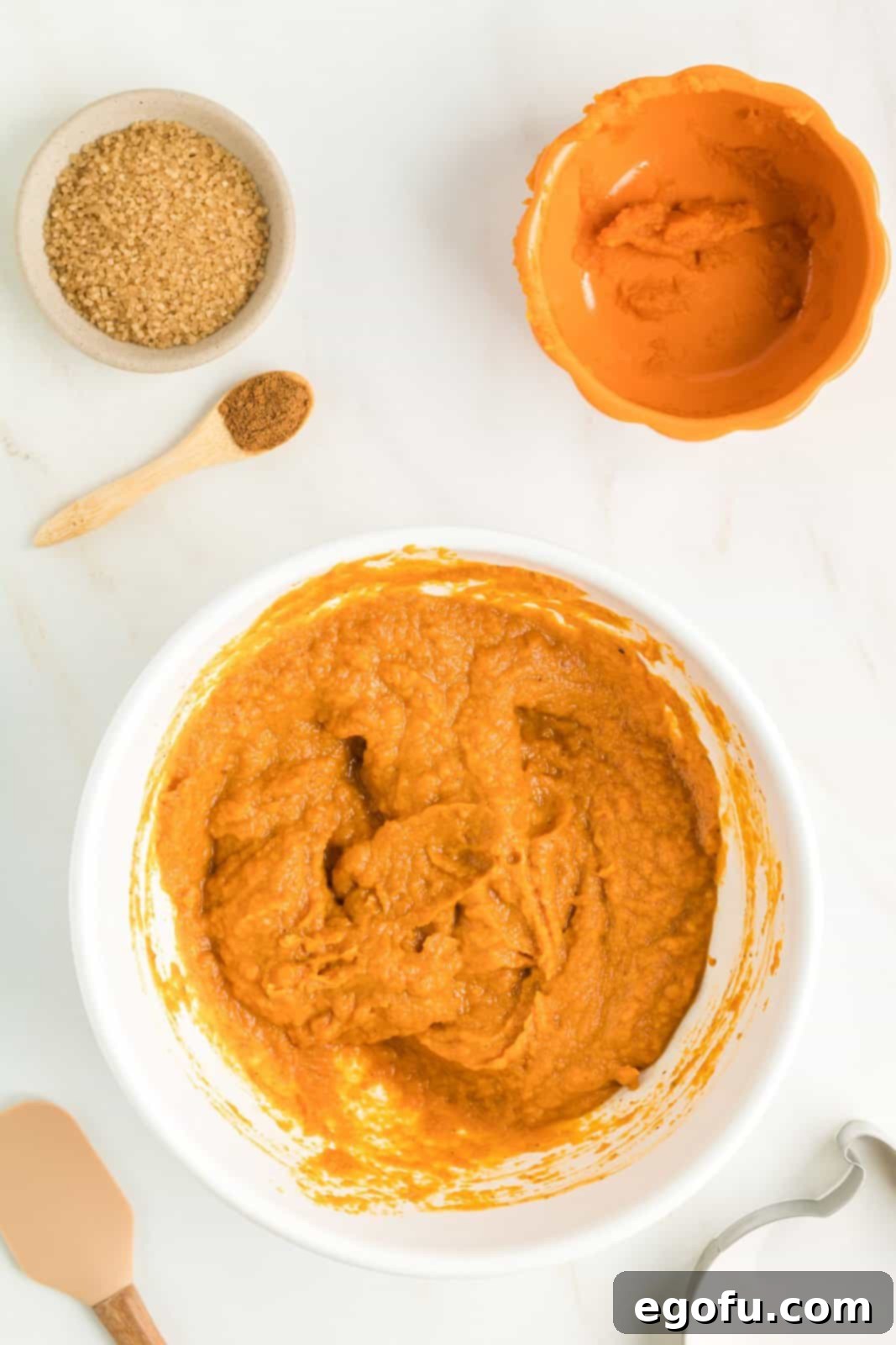 Pie filling ingredients mixed up in white bowl.