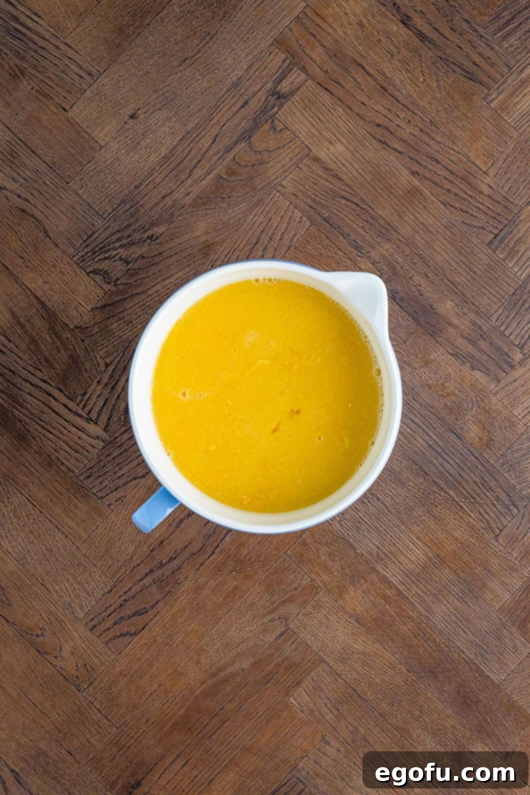 Corn, stock and egg mixture whisked together in bowl.