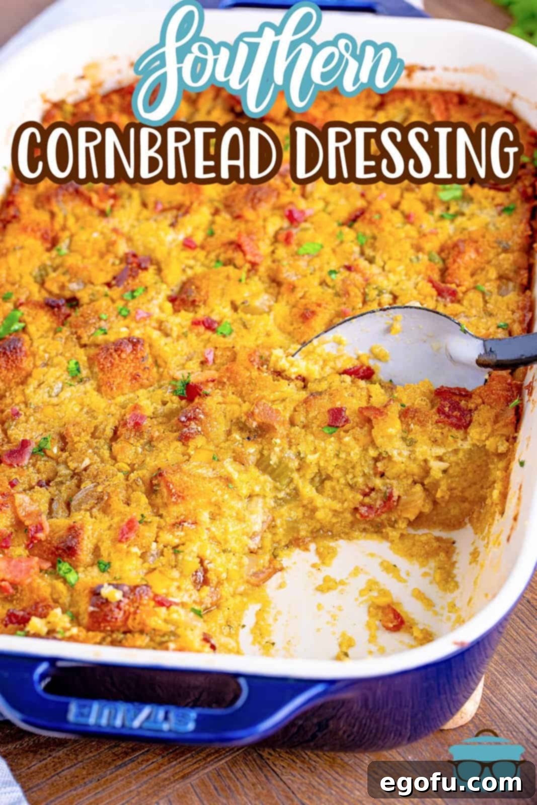 Pinterest image of Southern Cornbread Dressing with a scoop taken out with spoon in baking dish.