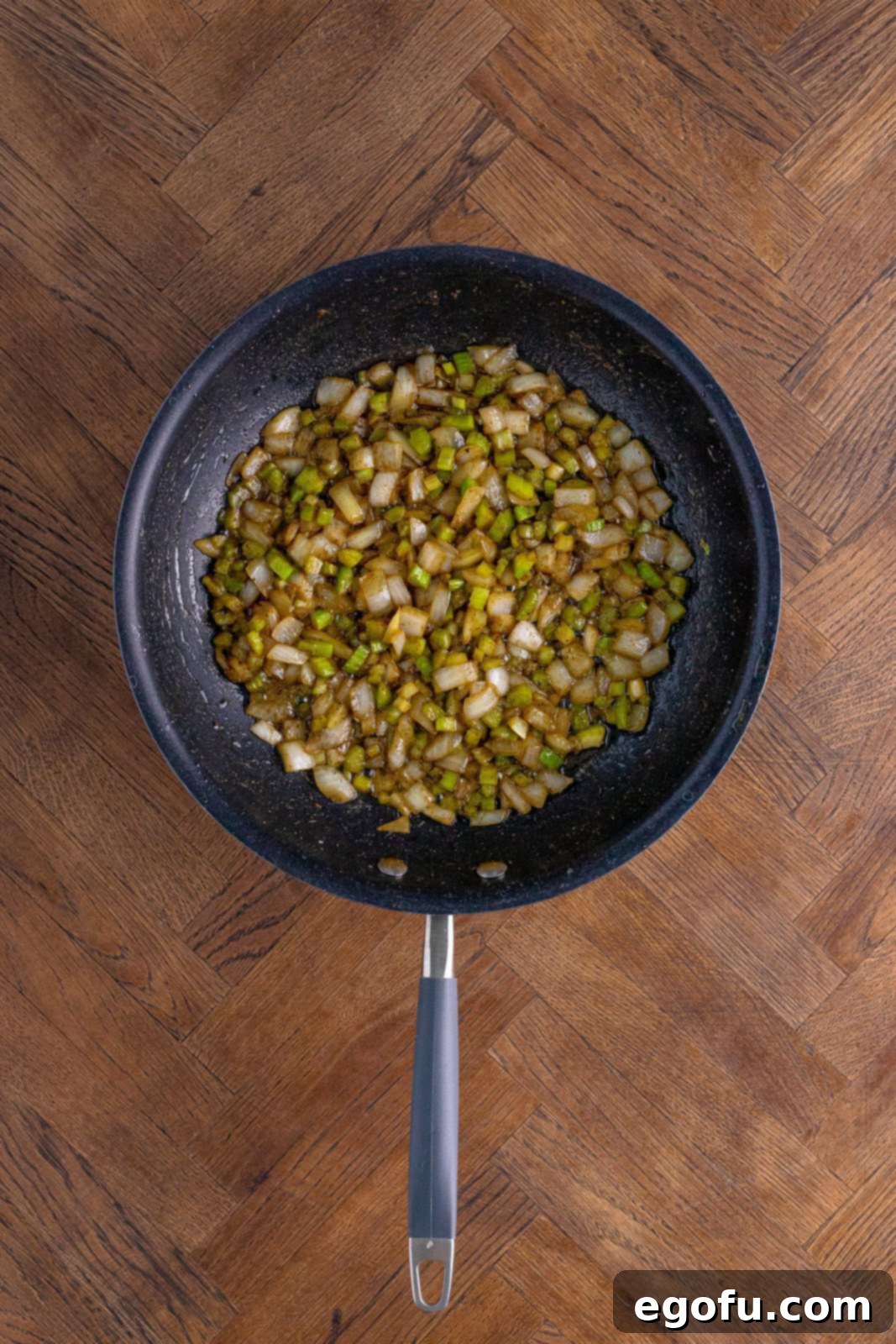 Onion, celery, sage, salt and garlic sautéing in pan.