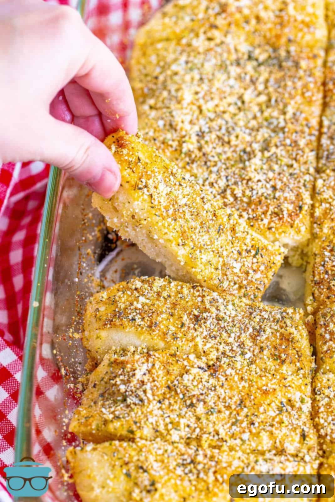 Pizza Hut's Signature Breadsticks 2 Hand holding up one of the Pizza Hut Breadsticks from baking pan.