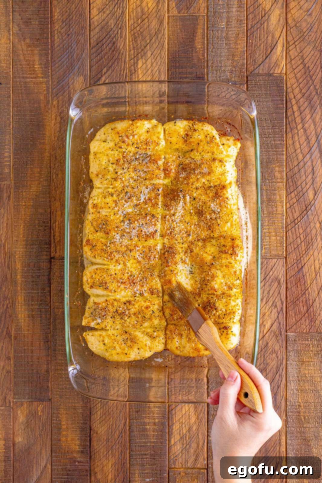 Pizza Hut's Signature Breadsticks 12 Finished breadsticks being brushed with butter.