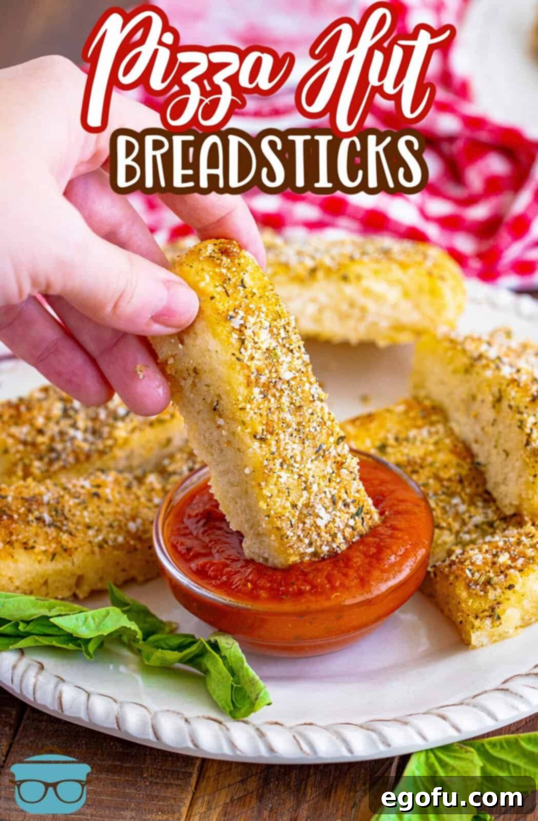 Pizza Hut's Signature Breadsticks 3 Hand dipping one of the Pizza Hut Breadsticks into marinara sauce.