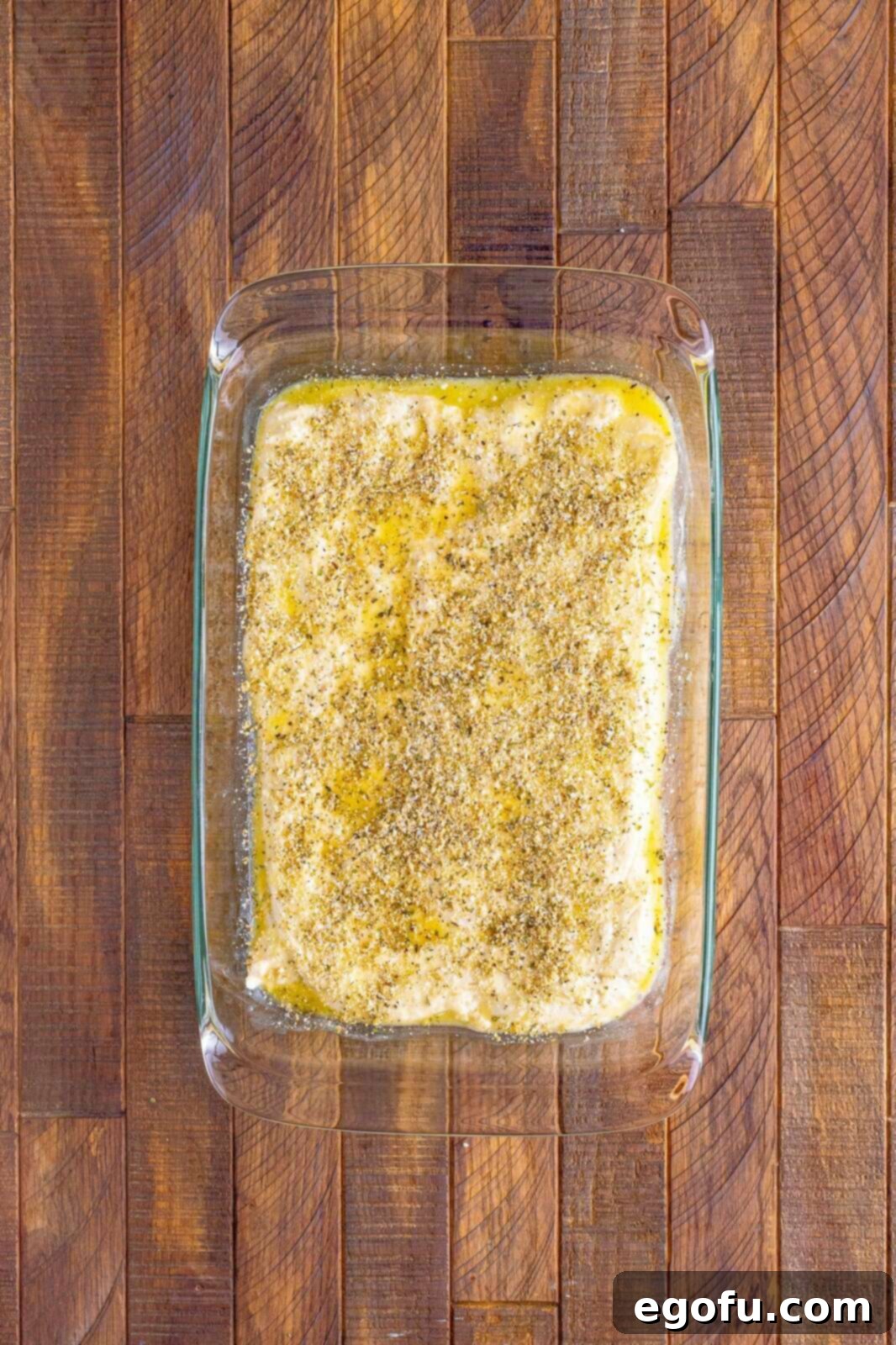 Pizza Hut's Signature Breadsticks 9 Seasoning mixture sprinkled over pizza dough.