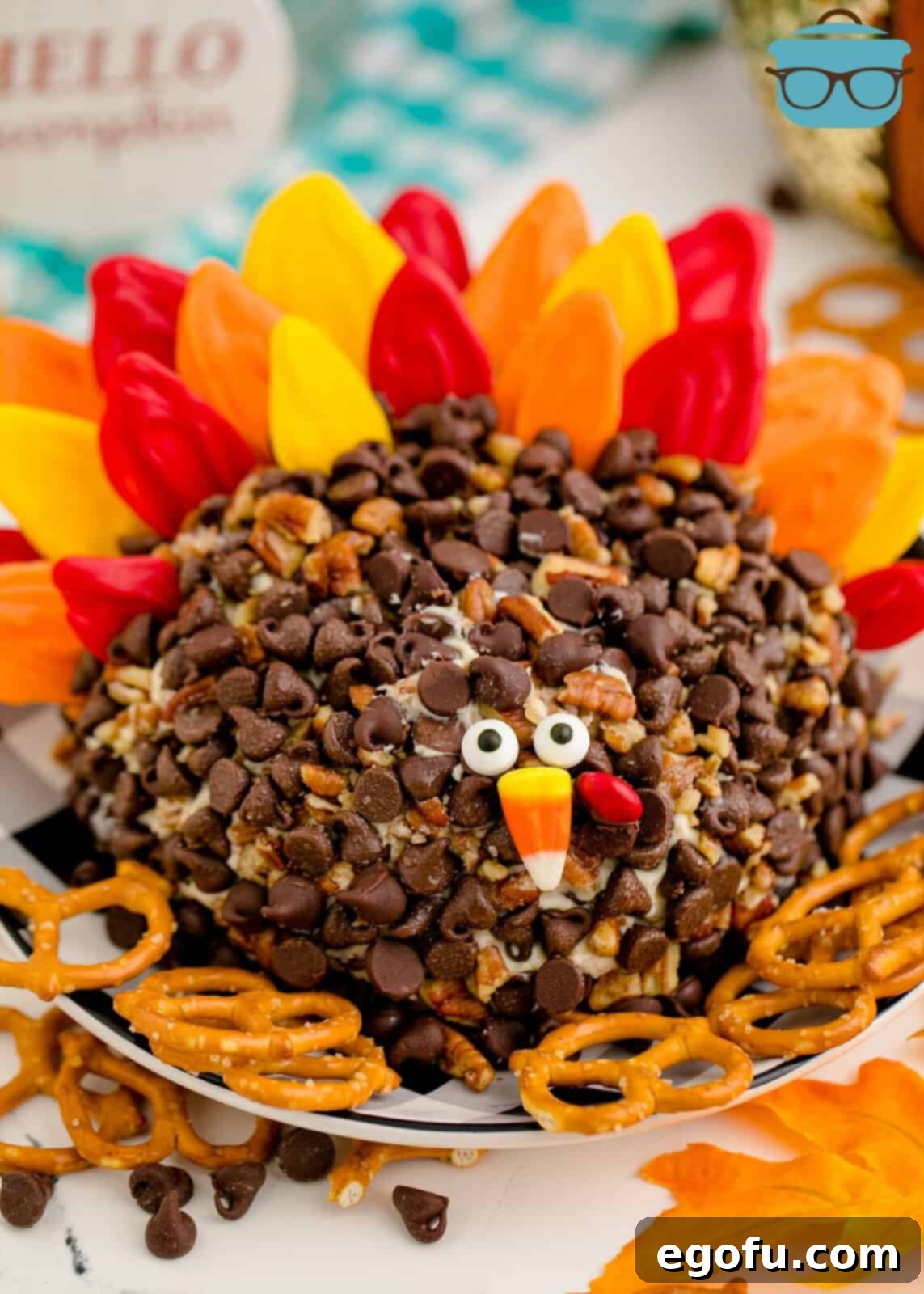Finished Turkey Dessert Cheeseball on plate with various dippers like pretzels and cookies, ready for serving.