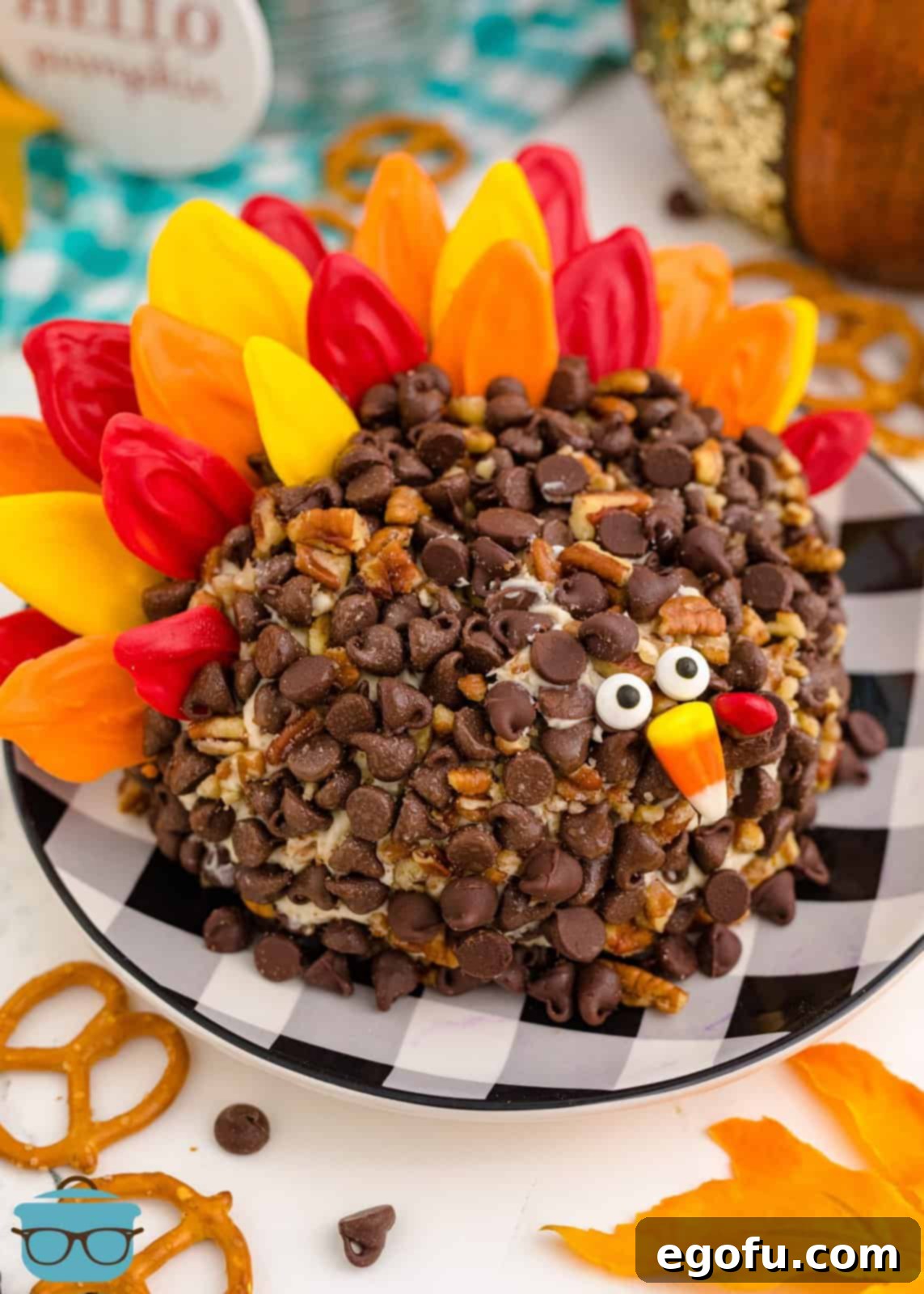 An inviting overhead shot of the finished Turkey Dessert Cheeseball on a festive checkered plate, ready to be enjoyed.