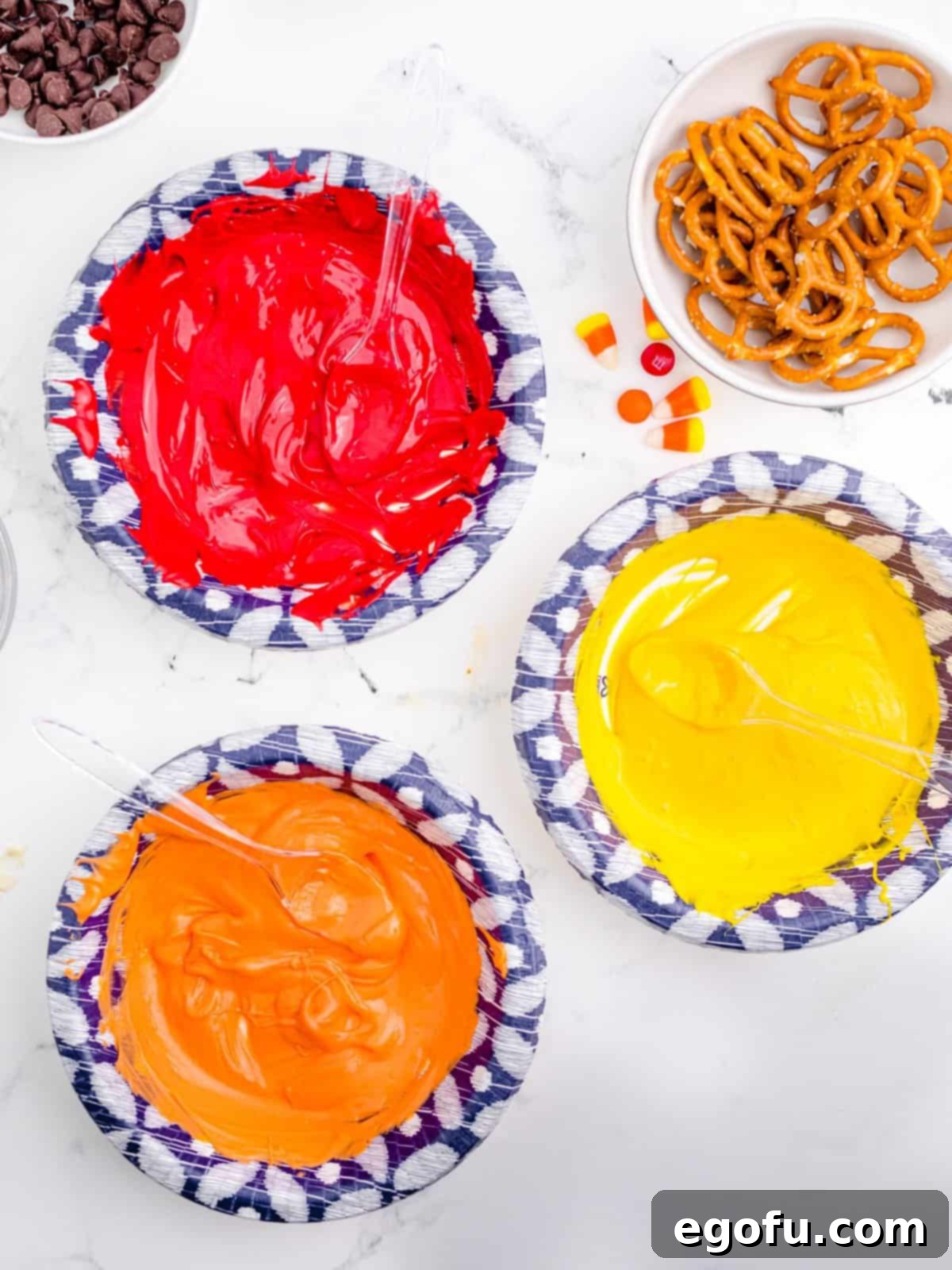Red, orange, and yellow candy melts, perfectly melted and ready for shaping into feathers.