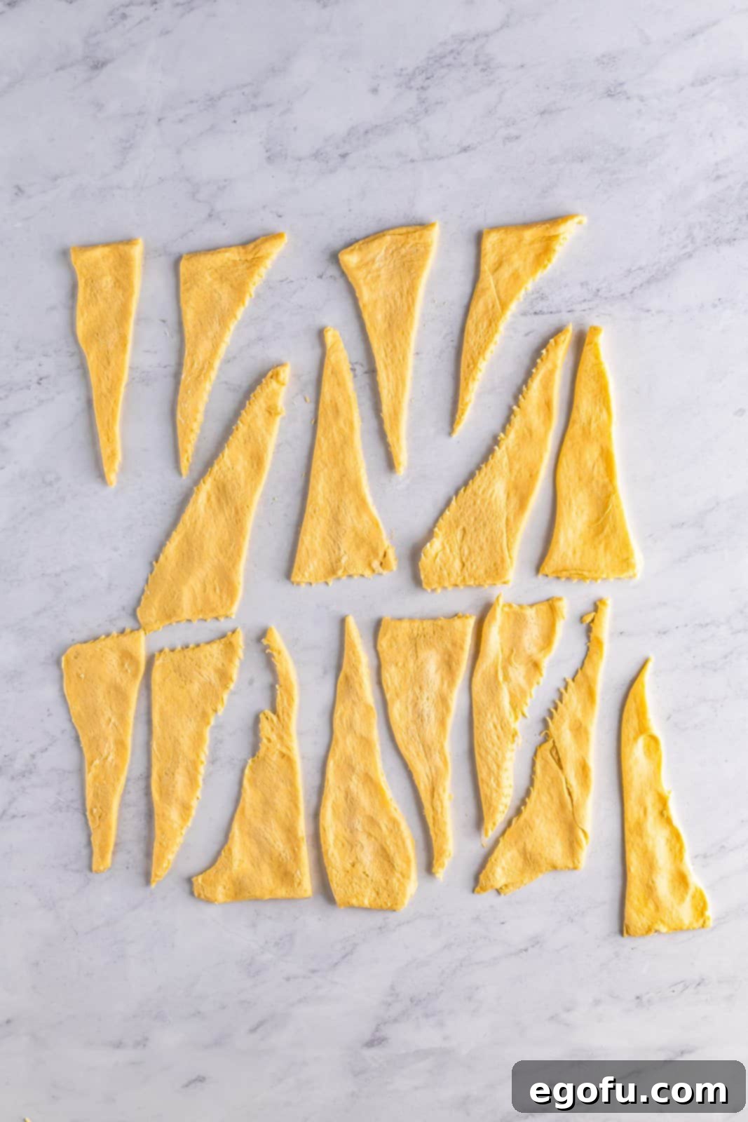 Crescent rolls cut and separated into smaller triangles.