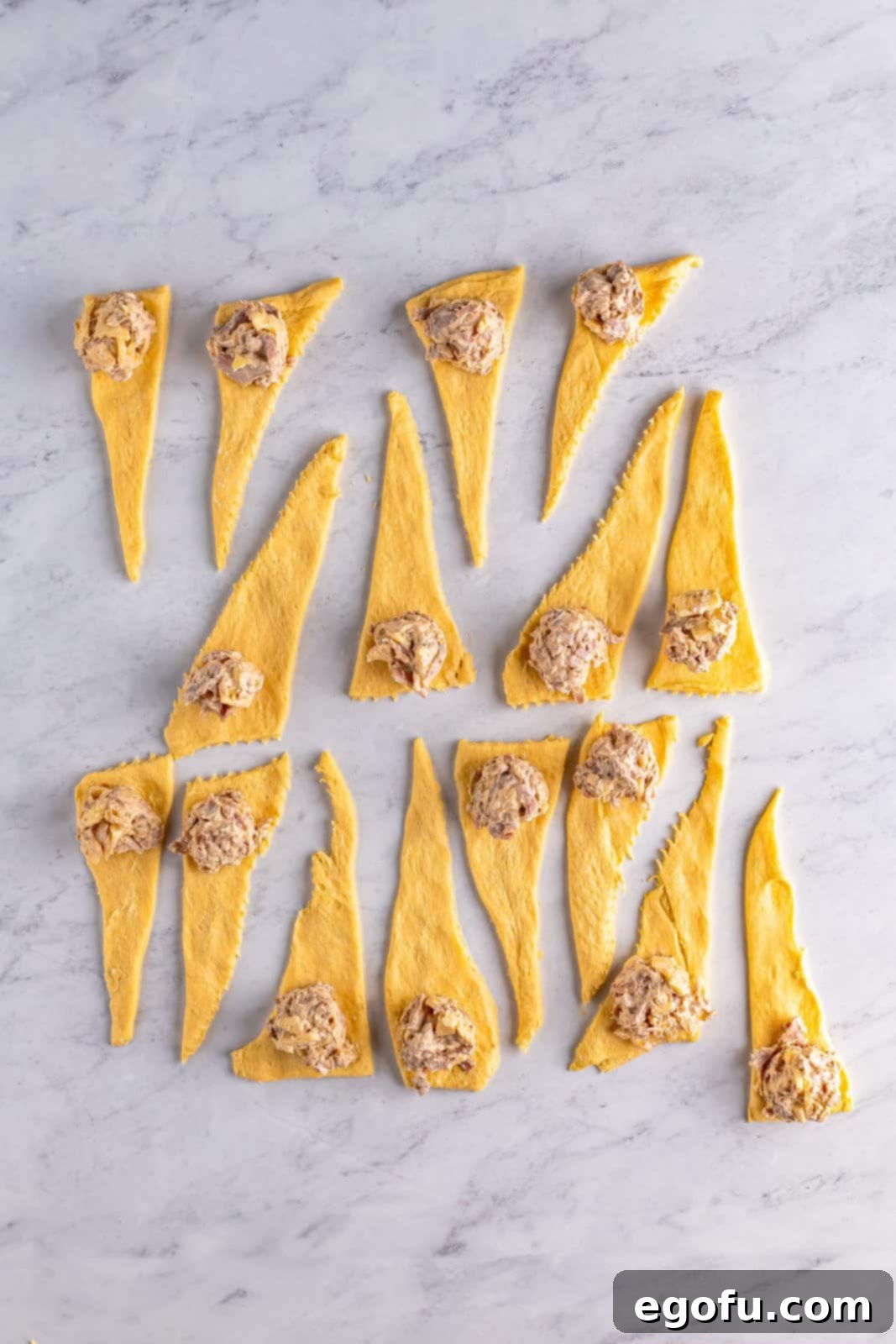 Filling placed on wide end of cut crescent rolls.