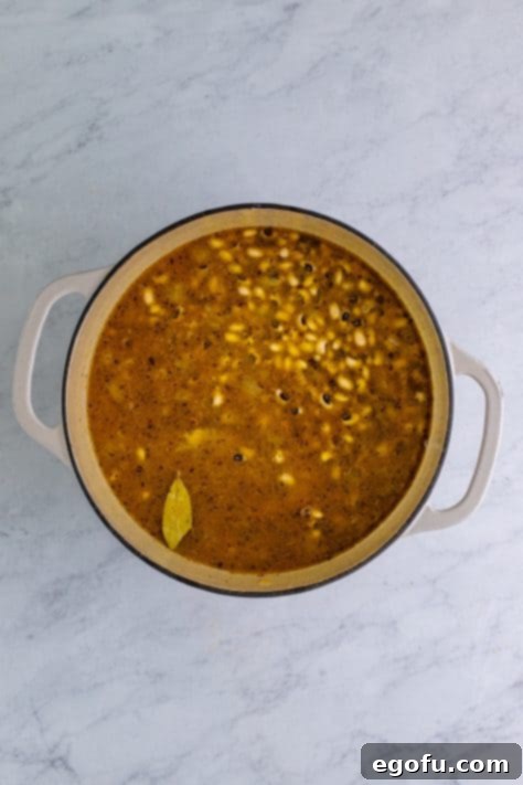 Down South Black Eyed Peas 14 Black eyed peas, chicken stock and bay leaves added to dutch oven and stirred.