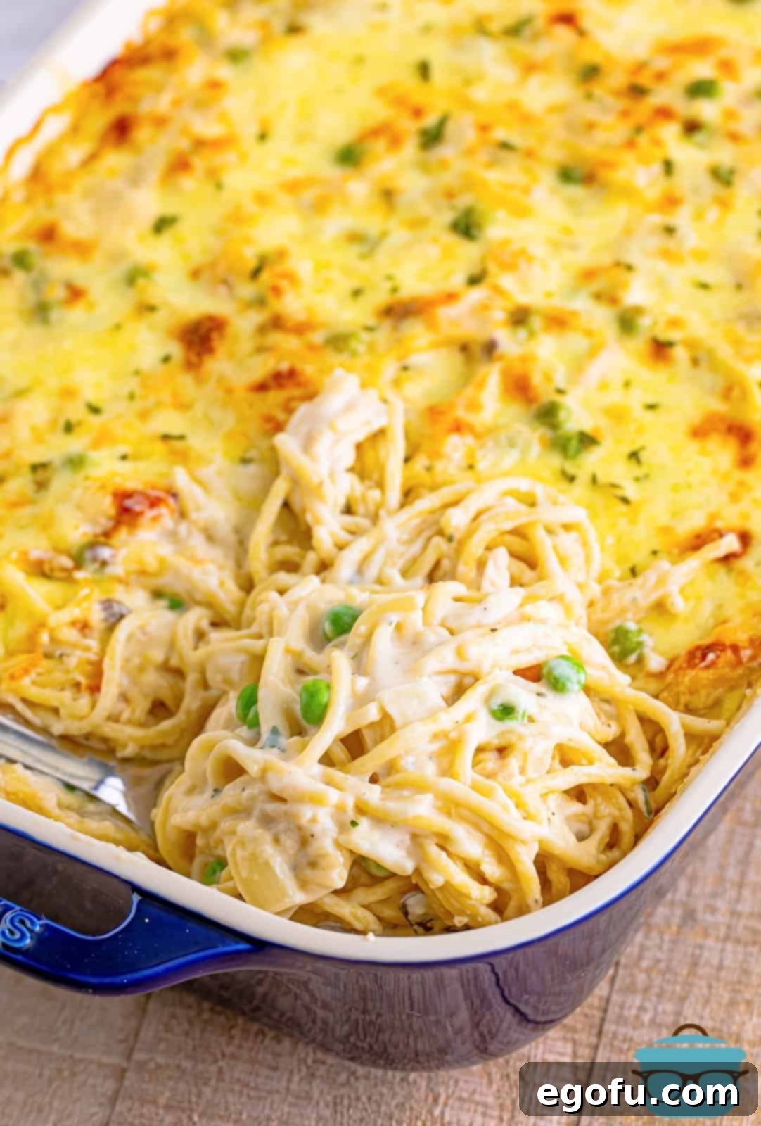 Serving spoon in baking dish with Easy Chicken Tetrazzini.