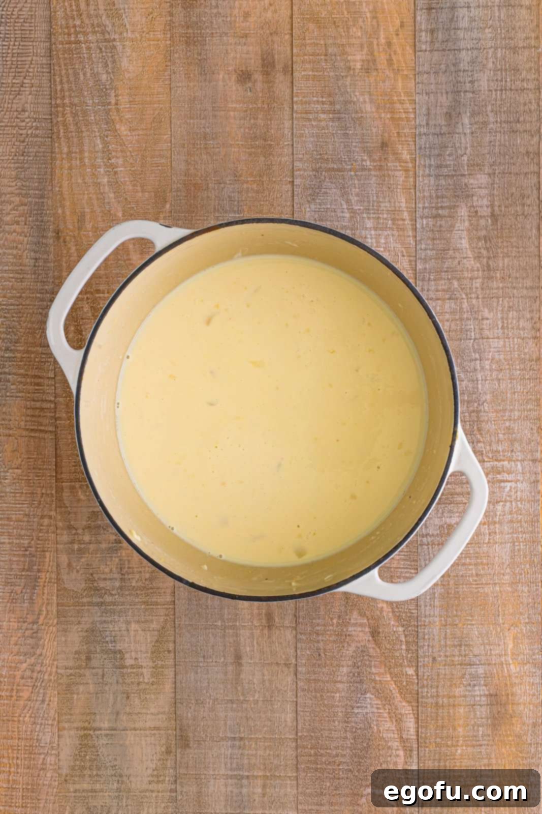 Milk and chicken stock added to dutch oven.