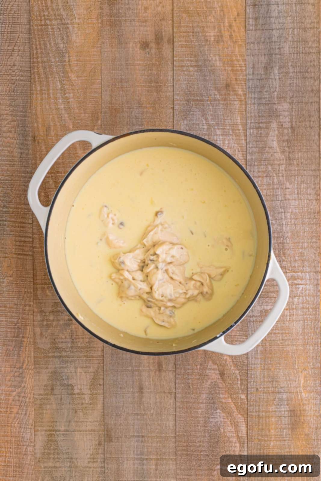 Cream of mushroom soup added to dutch oven.