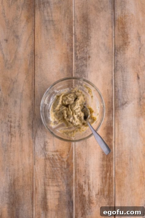 Butter, garlic powder, onion powder, salt, pepper, parsley, rosemary, sage, and thyme mixed together in bowl.